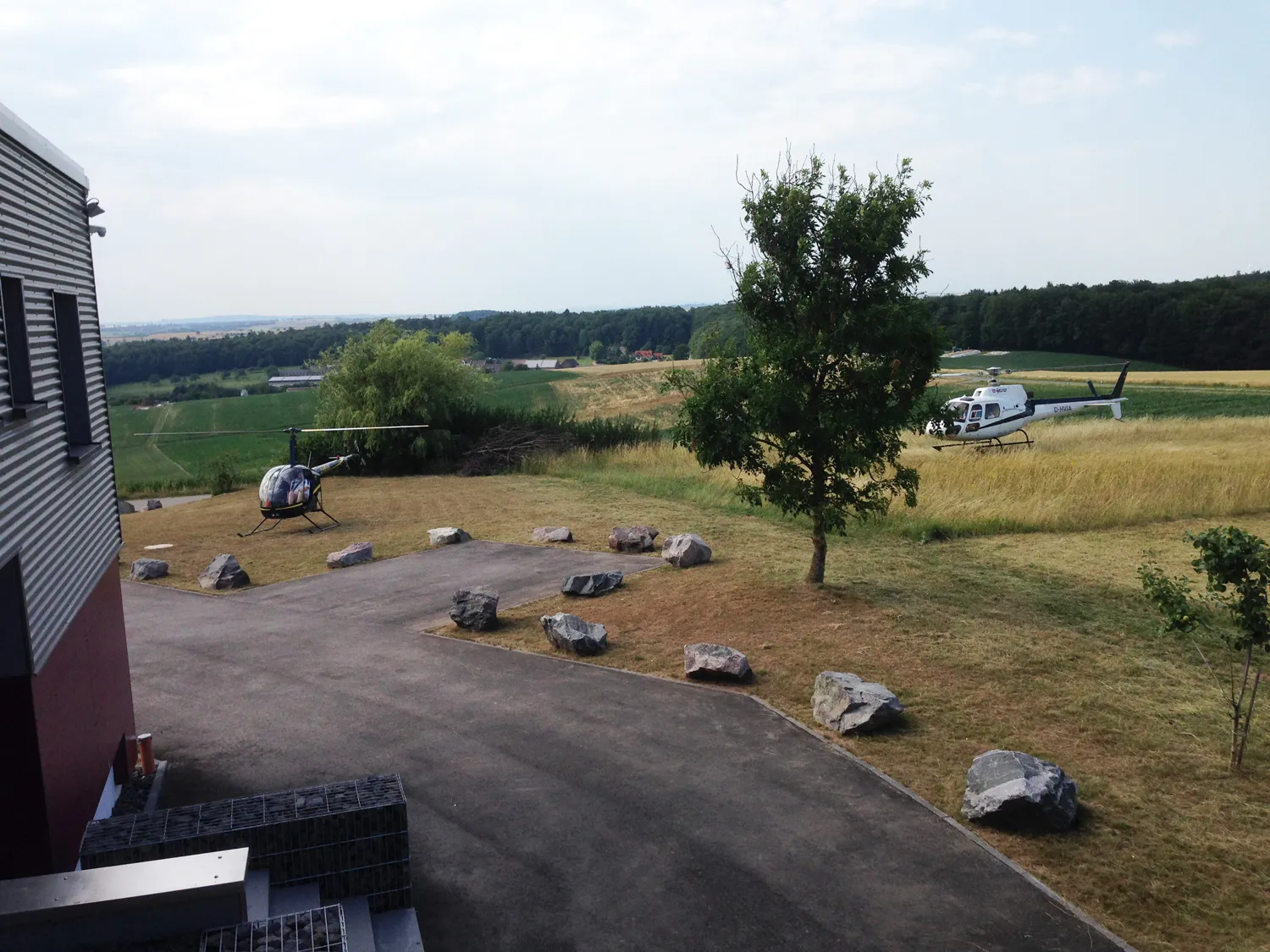 Hubschrauber an einer Landestelle in hügeliger Landschaft
